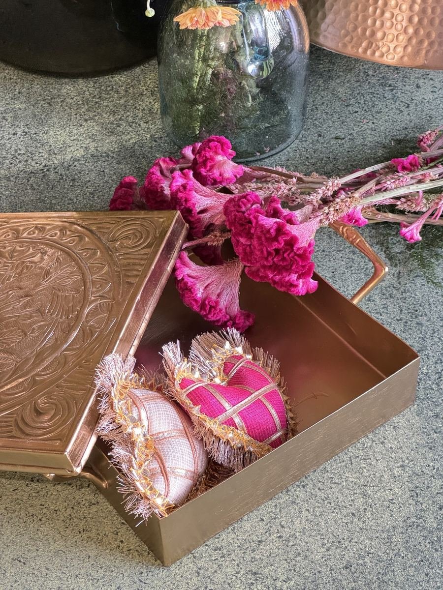 Silk potlis and celosia in a brass tray